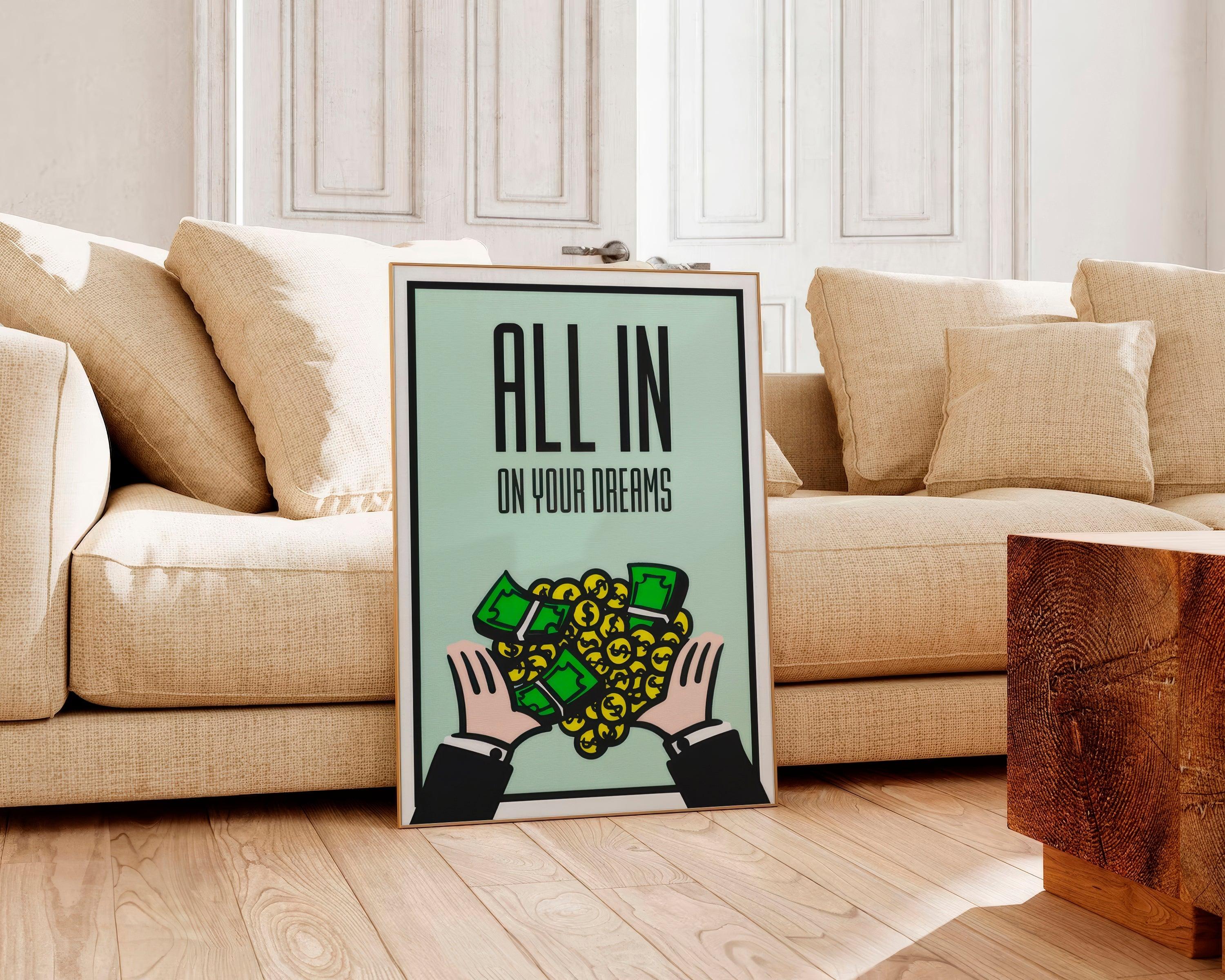 Framed money poster with hands catching cash and gold coins resting against a beige linen sofa